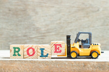 Toy Forklift Hold Letter Block E To Complete Word Role On Wood Background