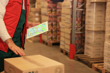 Poster - Man with tablet working at warehouse, closeup. Logistics center