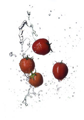 Sticker - Fresh red Tomatoes in splash of water Isolated on white background