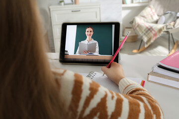 Wall Mural - Cute little girl with modern tablet at online lesson, closeup. E-learning