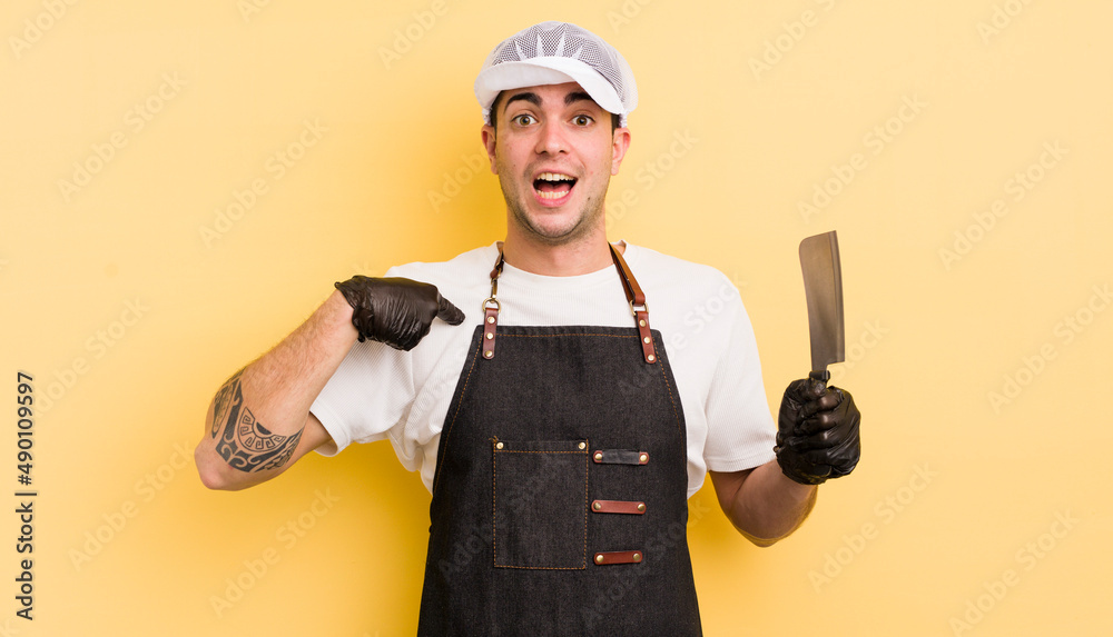 young handsome man feeling happy and pointing to self with an excited. butcher concept
