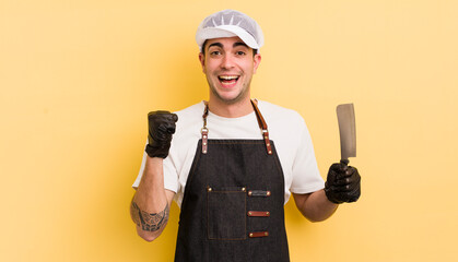 Wall Mural - young handsome man feeling shocked,laughing and celebrating success. butcher concept