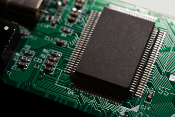 Canvas Print - Macro photo of a green computer printed circuit board with selective focus on an blank chip.