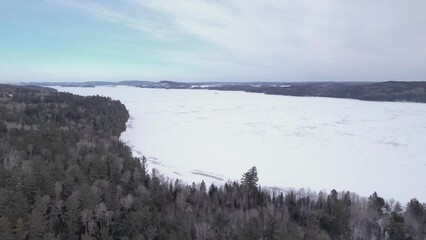 Wall Mural - Aerial Flying During Winter Over Frozen Ottawa River - Northern Ontario Canada