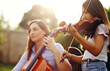 © Lyndon Stratford/peopleimages.com - Music runs in the family. Cropped shot of a mother and daughter playing musical instruments together in the backyard.