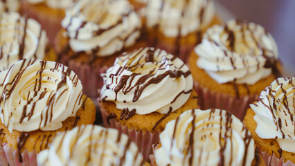 Sticker - Closeup shot of cupcakes drizzled in chocolate with a blurry background