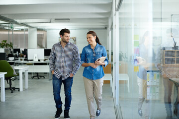 Poster - Ill walk you out. Shot of two colleagues talking while walking in the office.