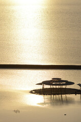 scenic view of a decorative floating island with two tourists looking at the ocean