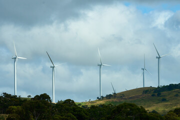 Sticker - Scenic view of windmills on a rural area on cloudy sky background