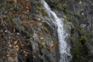 Wall Mural - Selective focus shot of waterfalls in the mountain cliff