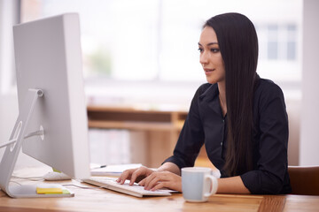 Poster - Living in a corporate world. Shot of a young businesswoman in her office.