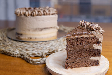 Poster - Closeup shot of delicious chocolate cake with a cut piece