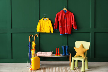 Interior of hallway with child's raincoats, gumboots and umbrellas