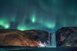 aurora borealis over skogafoss waterfall in iceland