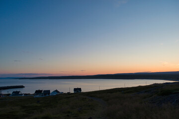 Canvas Print - Beautiful shot of a fjord with houses in Ekkeroy, Varanger, Norway at sunset