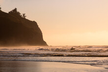 Silhouette Of Lone Surfer In Golden Hour Surf.  Photographed At Trinidad State Beach In Trinidad California, USA.  