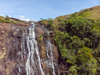 Poster - Beautiful photo of a waterfall, rocks and trees in nature on a sunny day