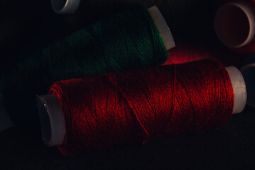 Poster - Closeup of colorful nylon threads set on a dark background