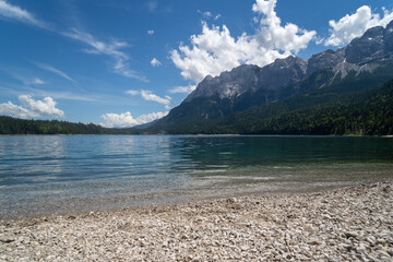 Wall Mural - Scenic view of a lake near an alpine mountain