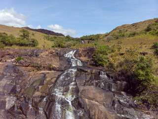 Sticker - Beautiful photo of a waterfall, rocks and trees in nature on a sunny day