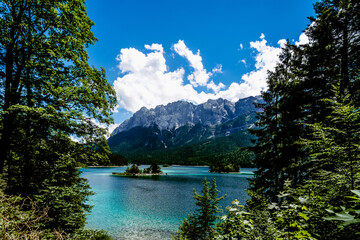 Wall Mural - Scenic view of a lake in the forest near an alpine mountain