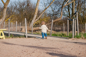 Wall Mural - Small toddler boy running on playground