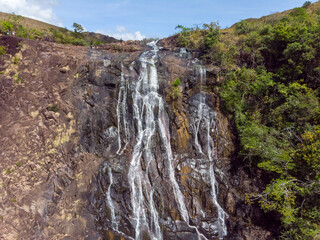 Sticker - Beautiful photo of a waterfall, rocks and trees in nature on a sunny day