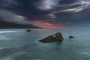 Wall Mural - scenic view of of dark clouds over a coast