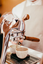 Shallow Focus Of A Male Hand Preparing A Cup For Grounded Coffee With A Coffee Machine