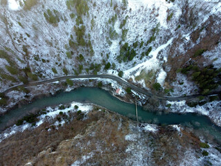 Poster - Birds eye view shot of mountain road and a long river during winter