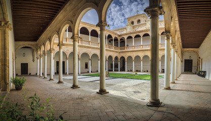 Canvas Print - Beautiful view of a paved and illuminated walkway with columns