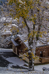 Sticker - Beautiful view of a small village among mountains covered by snow