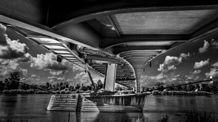 Canvas Print - Greyscale shot of the under of the bridge and a river