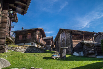 Wall Mural - Beautiful view of a small village with cute wooden houses under the blue sky