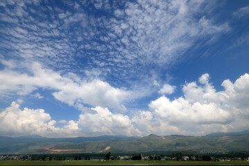 Wall Mural - long exposure of a cloudy sky over the hills