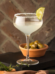 Wall Mural - Vertical shot of a citrus lime cocktail on a dinner table