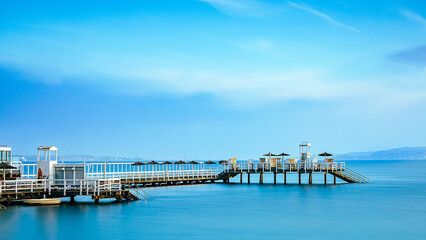 Wall Mural - Beautiful view of the pier against the blue sky and the sea.