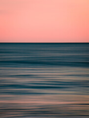 Wall Mural - beautiful vertical photo of the sea at sunset and clear sky