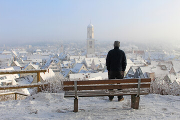 Canvas Print - Scenic view of an old man looking at the city of Biberach, Germany in winter