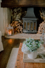 Poster - Vertical shot of a floral bouquet near a romantic fireplace