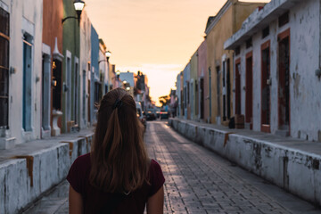 Wall Mural - Beautiful view of a girl standing near the houses in Campeche, Mexico