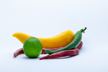 Canvas Print - Peppers and lime on a white background