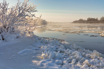 Sticker - Beautiful shot of a field covered in snow near the lake.