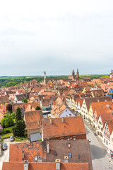 Sticker - Vertical shot of the houses with orange roof tiles in Rothenburg ob der Tauber, Germany