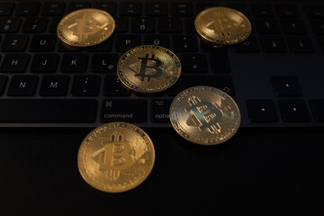 Sticker - Closeup shot of bitcoins on top of a dark keyboard