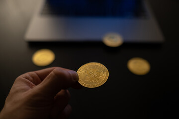 Sticker - Selective focus shot of a man holding a golden bitcoin