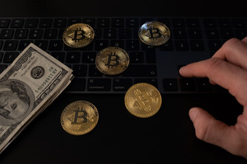 Sticker - Closeup shot of Bitcoin coins and dollar banknotes on a computer keyboard