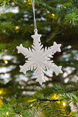 Sticker - Closeup shot of a snowflake Christmas tree ornament