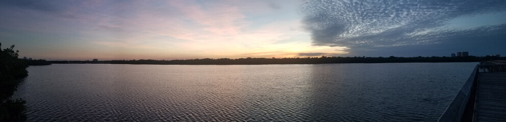 Wall Mural - Beautiful panoramic shot of a magnificent sunset over a lake