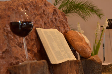 Poster - Closeup of a glass of wine and a book on an orange rock